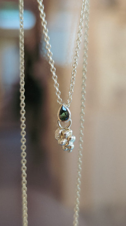 Grape pendant with tourmaline on chain.