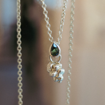 Grape pendant with tourmaline on chain.